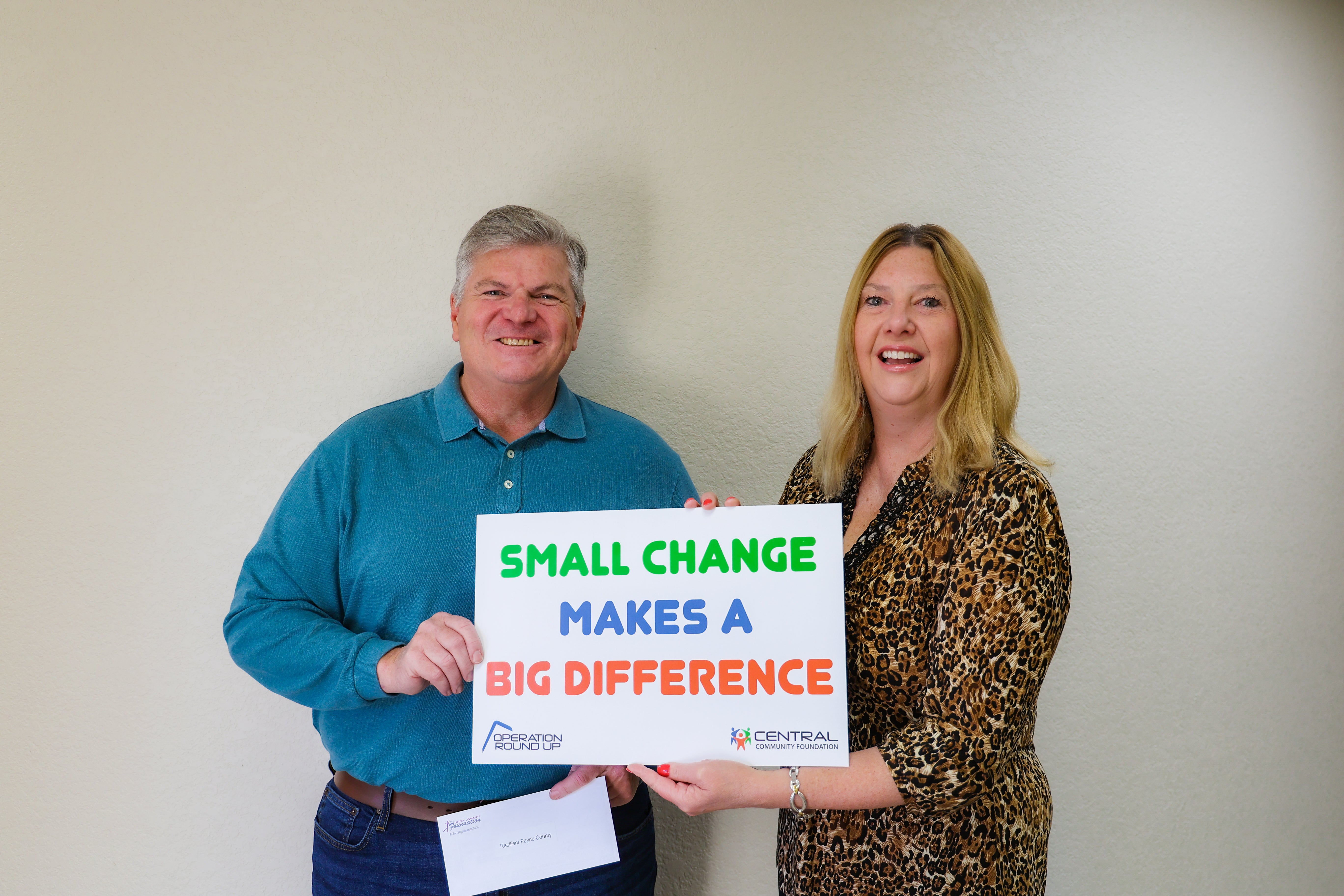 Resilient Payne County board member Jim Rice and board president Sheri Carter accepts a Central Community Foundation grant for their upcoming event. 