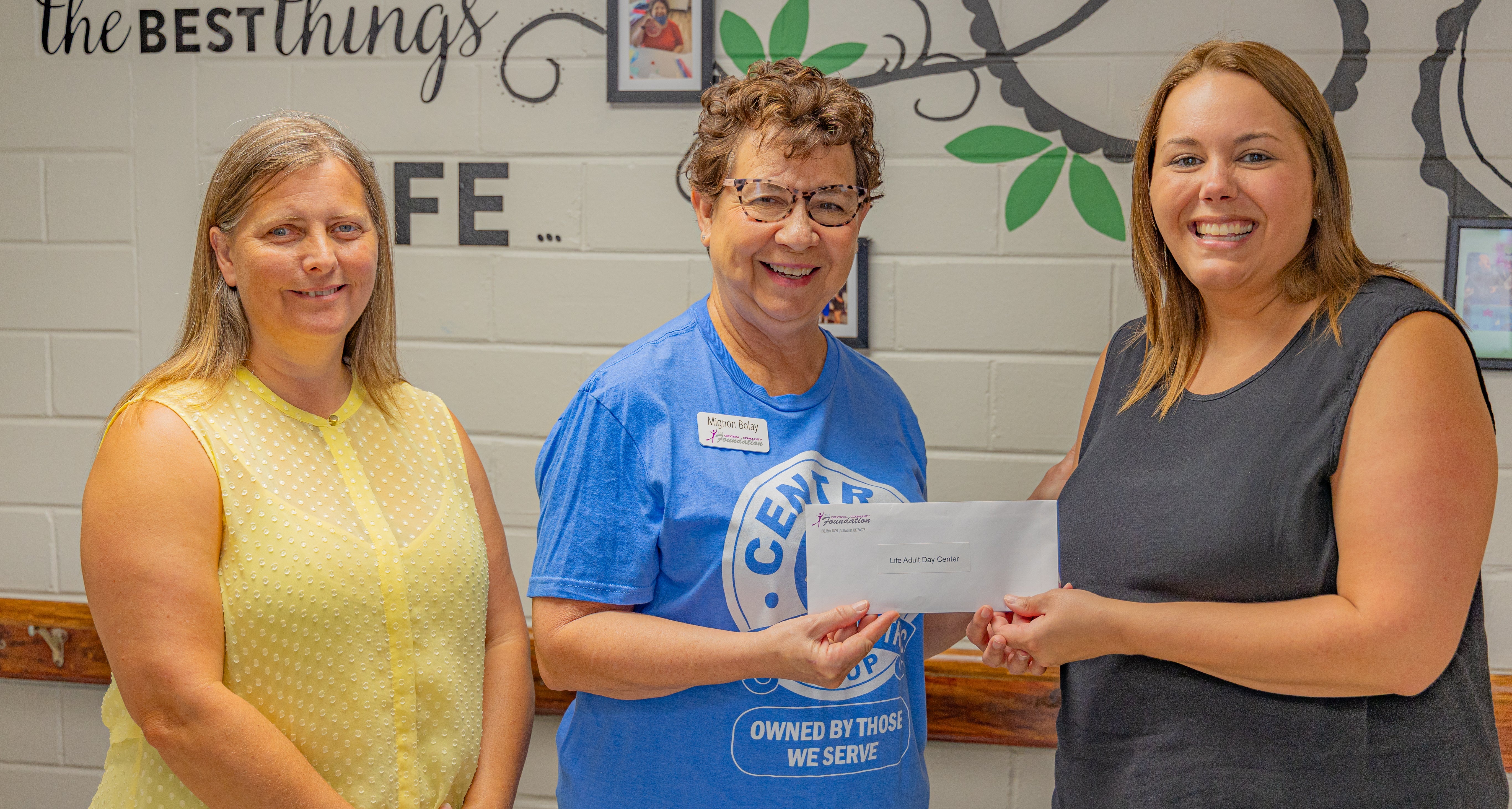 Central Community Foundation board member, Mignon Bolay, presents Life Adult Day Center’s Kristy Moorman and Maribeth Outhier with a grant.