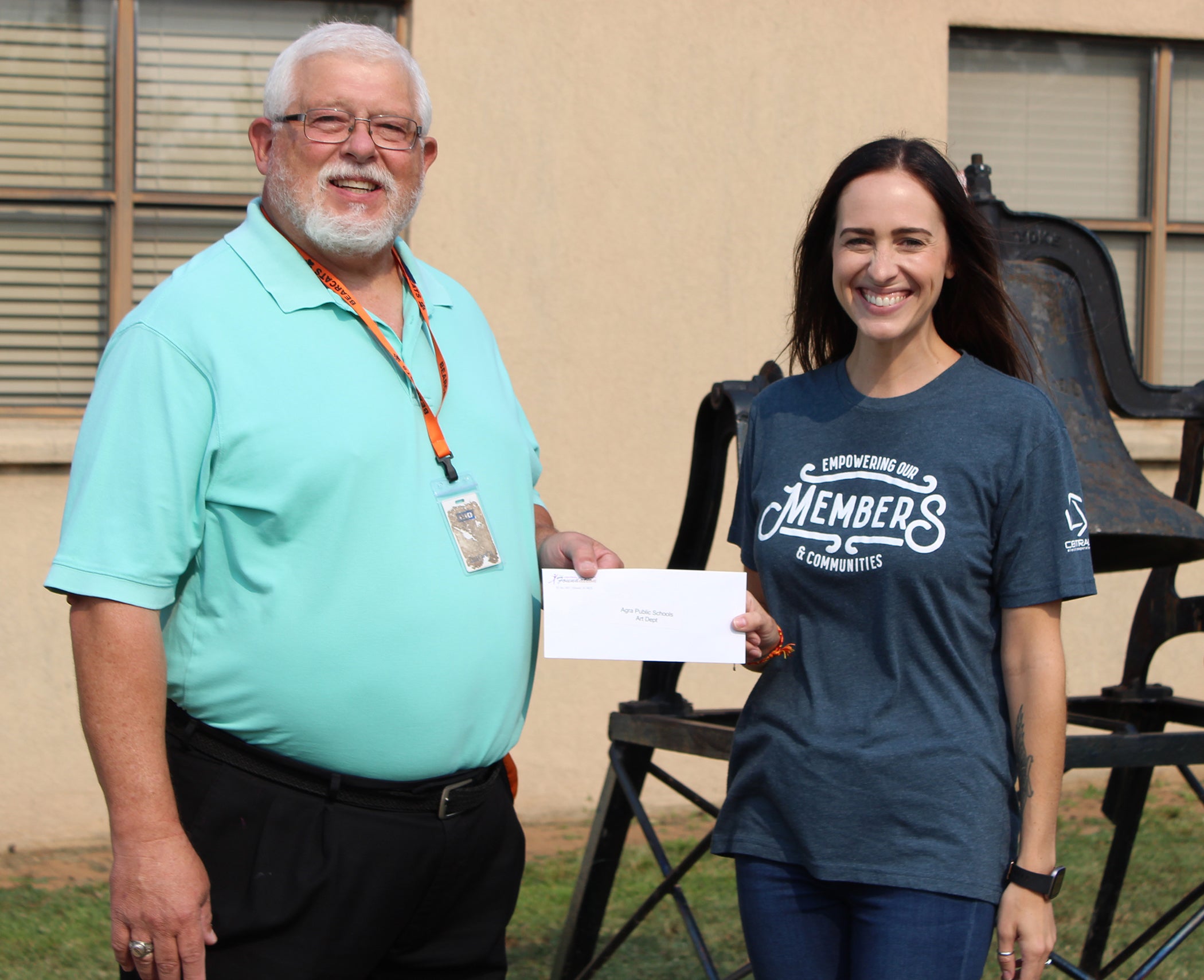 Central Community Foundation Coordinator, Erin Talley, presents Agra Public Schools art instructor, James Patrick with grant for classroom supplies.