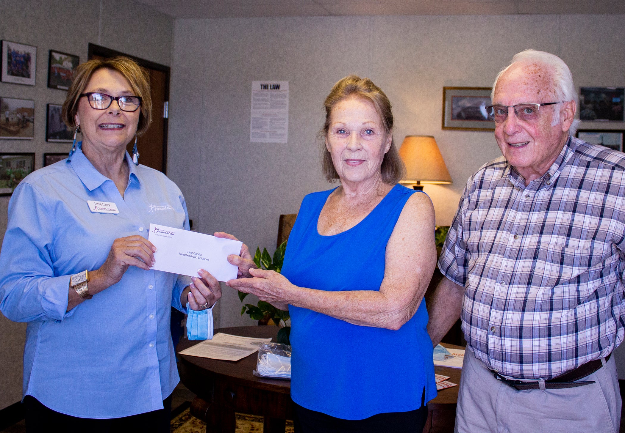 Janie Carey, Central Foundation board member presents Neighborhood Solutions Director, Sue DuCharme, and Administrative Coordinator, Bob Cook, with Central Foundation grant.