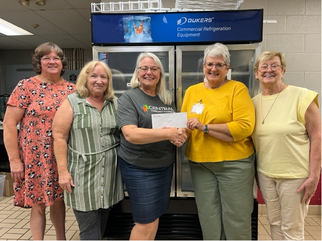 Central Foundation board member Donna Dollins presents Home and Community Education board members Misty Burk, LeeAnn Barton, Pat McNally and Dee Porter with a grant to help cover the cost of a new refrigerator.