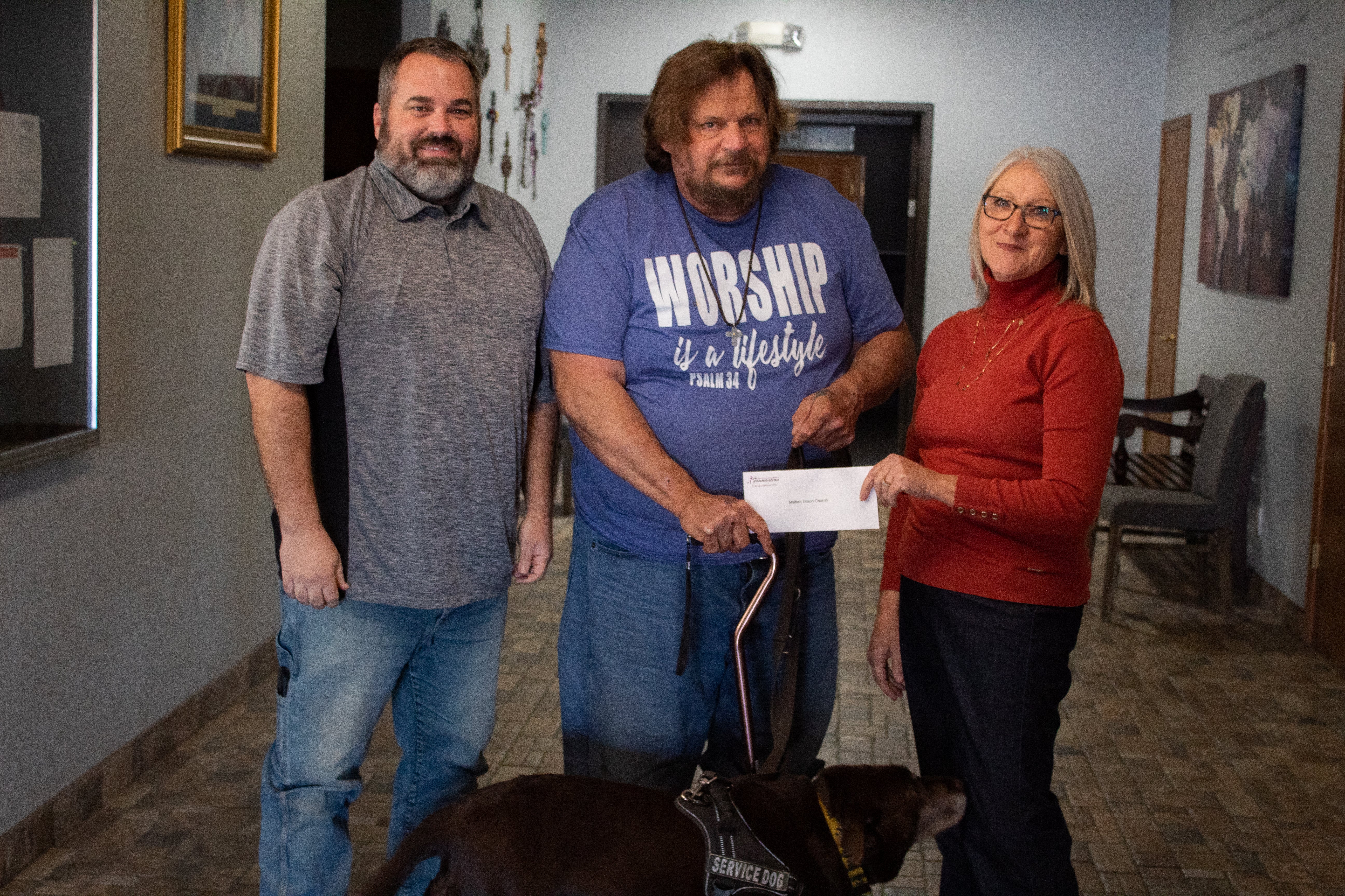 (From left to right) Mehan Union Church lead pastor, Jeff Eskelson, and volunteer, Toby Tiner, receive a grant from Central Community Foundation board member Gail Cookerly.
