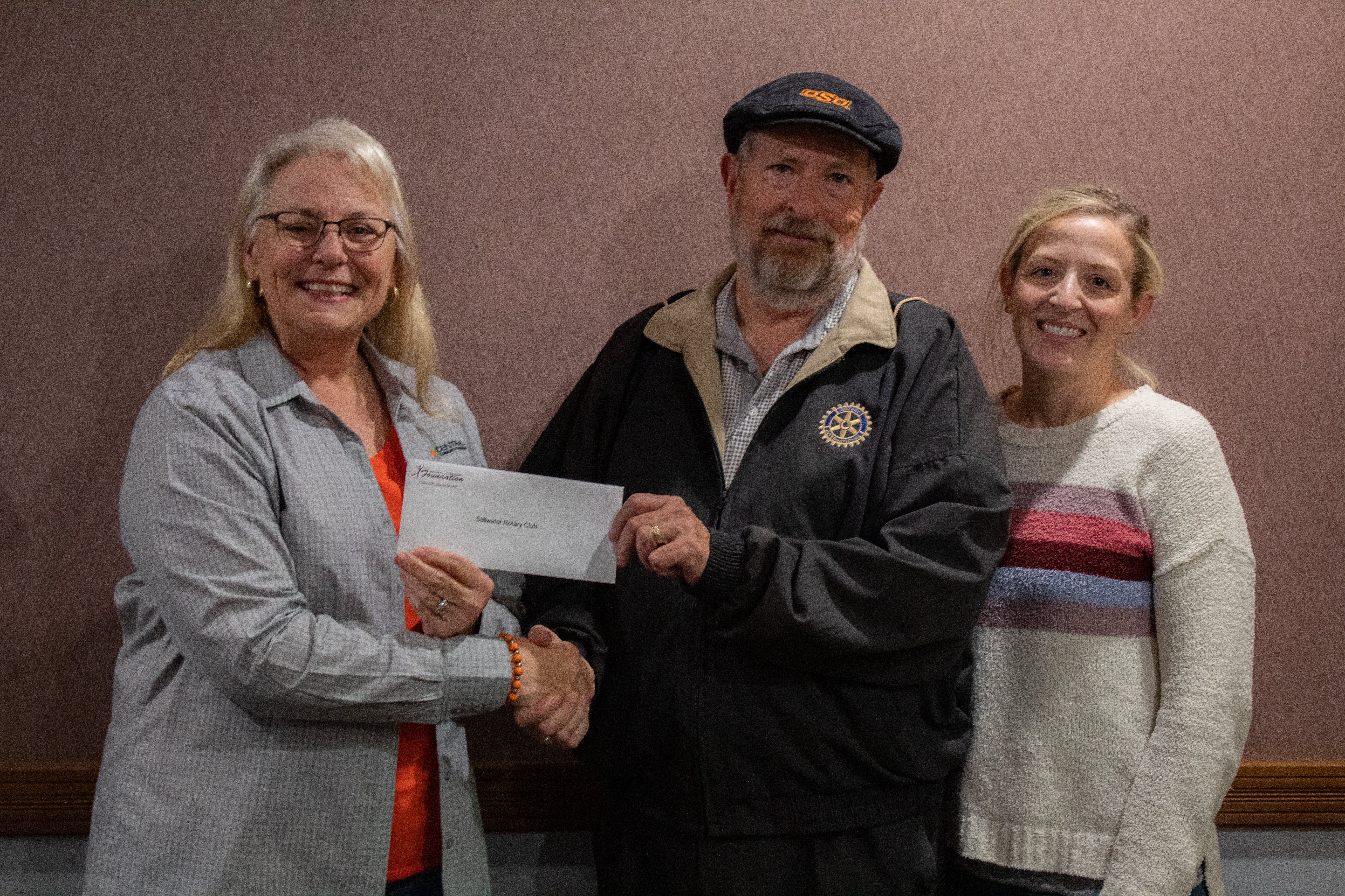 (From left to right) Central Community Foundation board member Donna Dollins presents Stillwater Rotary Club members Steven Cundiff and Sabrina Deveny with a foundation grant. 