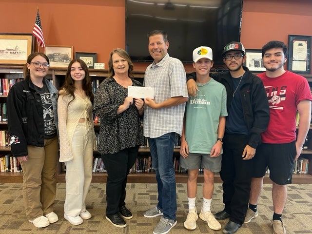 Central board member Greg Tytenicz presented Luther High School special services teacher Melody Seather and her leadership class with a grant for the Caring Closet starting at the school this year.