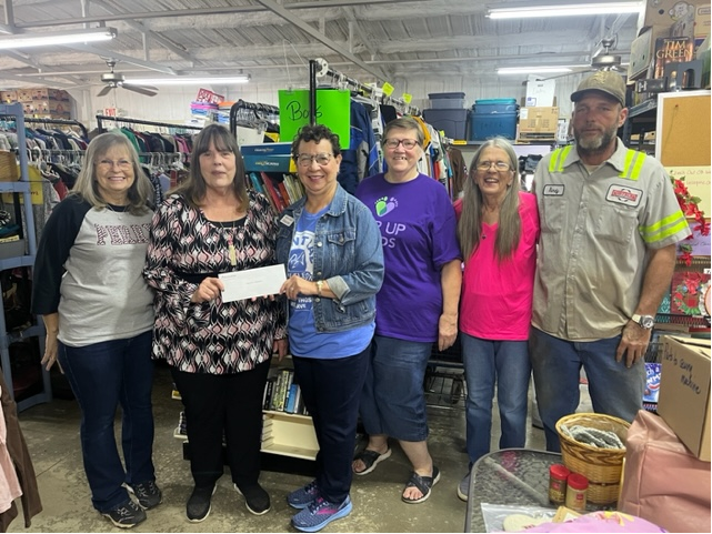 From left to right: Connie Mendenhall, Lou Ann Hunt, Central Community Foundation board member Mignon Bolay, Sandy Ellis, Sharon Sewell, Randy Watson pose for a photo in the Operation Blessing shopping center.