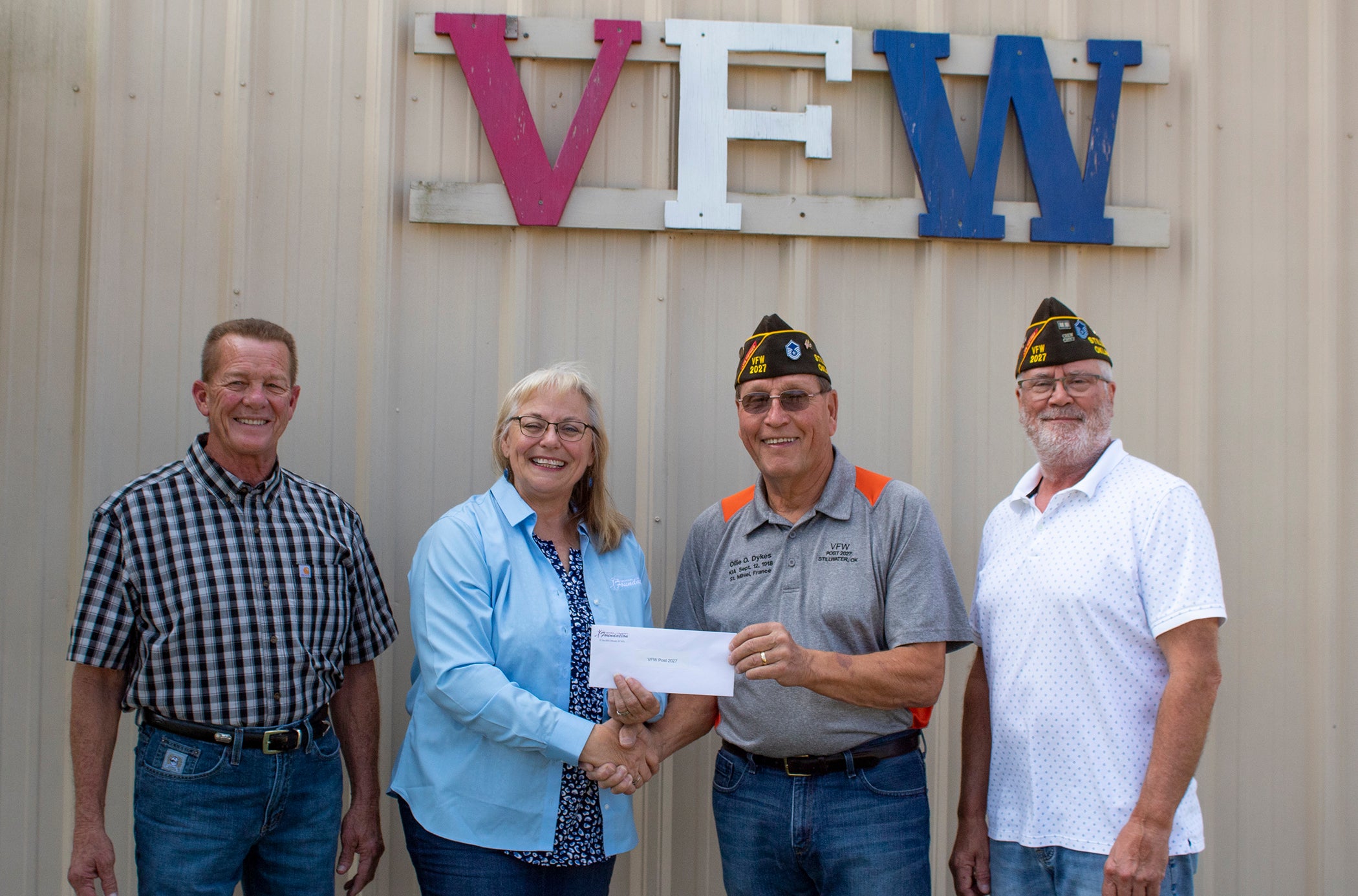 (From left to right) Central District 5 Trustee Mark Pittman and Central Community Foundation Board Member Donna Dollins present Stillwater VFW members Bill Jones and Brian Johnson with a foundation grant.